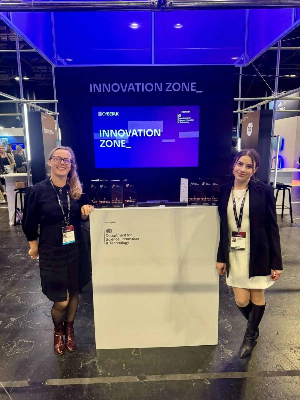 Olesya Danylchenko and Ksenia Bulhakova at the booth in the Innovation Zone at Cyber UK